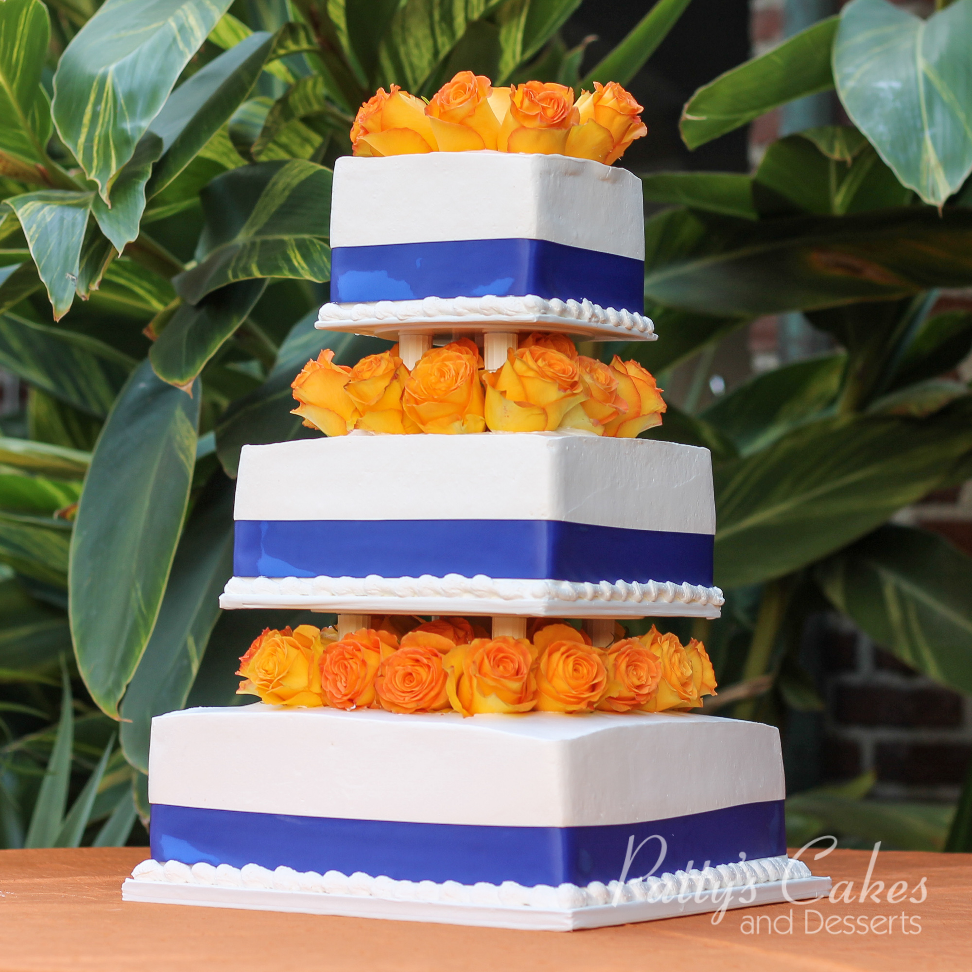 blue-ribbon-orange-flowers-white-wedding-cake